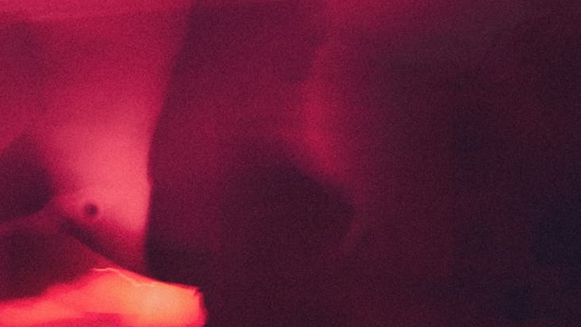 Person in a dynamic and fluid motion pose against a dark, atmospheric background.